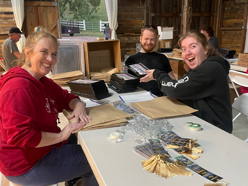 Registration crew packing up registration packets before the salute events